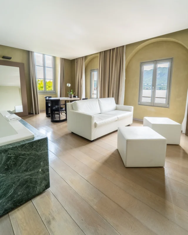 🌿 Quando il lago diventa la tua spa privata

Cinque finestre come altrettanti quadri viventi incorniciano l'Isola di San Giulio, mentre nella Suite Natura ogni elemento sussurra un dialogo intimo con il lago. La vasca idromassaggio con cromoterapia diventa un rifugio rigenerante dove i colori dell'acqua si fondono con quelli dei tramonti estivi, regalando momenti di puro relax dopo giornate intense sotto il sole.

La doccia-bagno turco in pietra naturale, con i suoi sei soffioni che disegnano geometrie d'acqua, trasforma ogni sera in un rituale di rinascita. Qui, cullati dai suoni del lago e avvolti dai vapori rigeneranti, il calore del giorno si dissolve in una dimensione di puro benessere, dove design italiano firmato e natura si incontrano in perfetta armonia.

✨ Vivi l'esperienza della Suite Natura: prenota il tuo rifugio sensoriale su www.hotelsanrocco.it

📍 Hotel San Rocco – Lago d'Orta 📞 Info: +39 0322 911977 ✉️ info@hotelsanrocco.it

🌿 When the lake becomes your private spa

Five windows frame San Giulio Island like living paintings, while in the Natura Suite every element whispers an intimate dialogue with the lake. The chromotherapy jacuzzi becomes a regenerating refuge where water colors blend with summer sunset hues, offering pure relaxation after intense days under the sun.

The natural stone Turkish bath shower, with its six jets drawing water geometries, transforms every evening into a rebirth ritual. Here, cradled by lake sounds and wrapped in regenerating vapors, the day's heat dissolves into a dimension of pure wellness, where signed Italian design and nature meet in perfect harmony.

✨ Experience the Natura Suite: book your sensory refuge at www.hotelsanrocco.it

📍 Hotel San Rocco – Lake Orta 📞 Info: +39 0322 911977 ✉️ info@hotelsanrocco.it